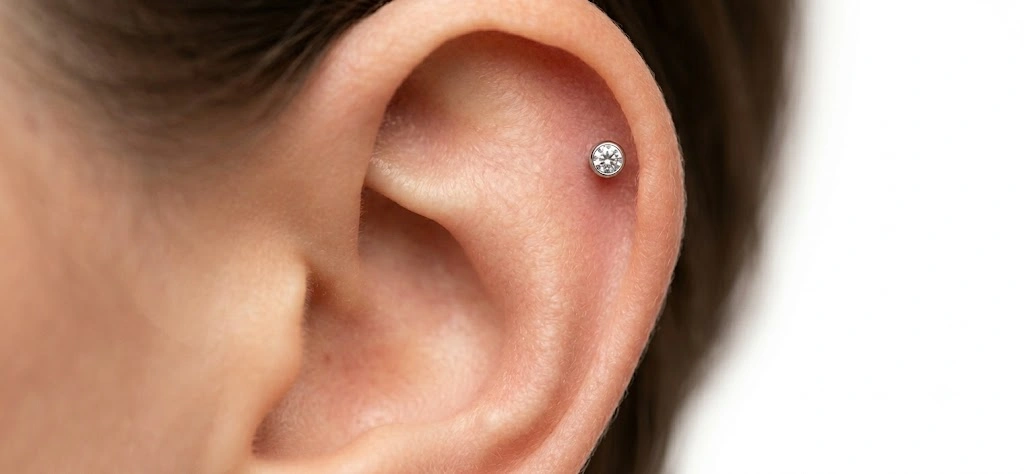 Single Helix Piercing 2 Single helix piercing on ear with flat-back stud